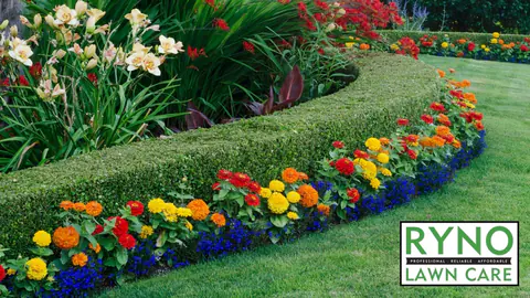 Curved garden bed with a clipped hedge and rows of seasonal color