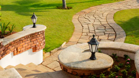 Flagstone walkway with a brick seat wall and path lighting