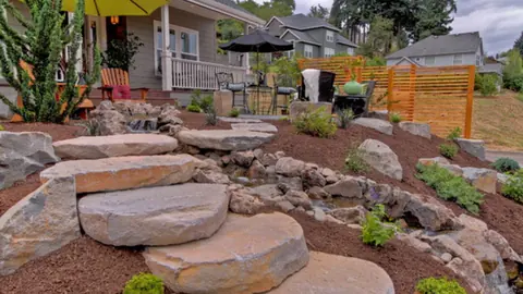 Large flagstone steps and rock garden beside a patio