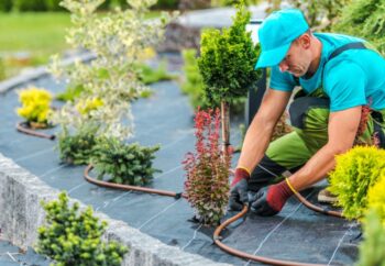 man working on sprinkler system-learn how to winterize your Rain Bird Sprinkler system